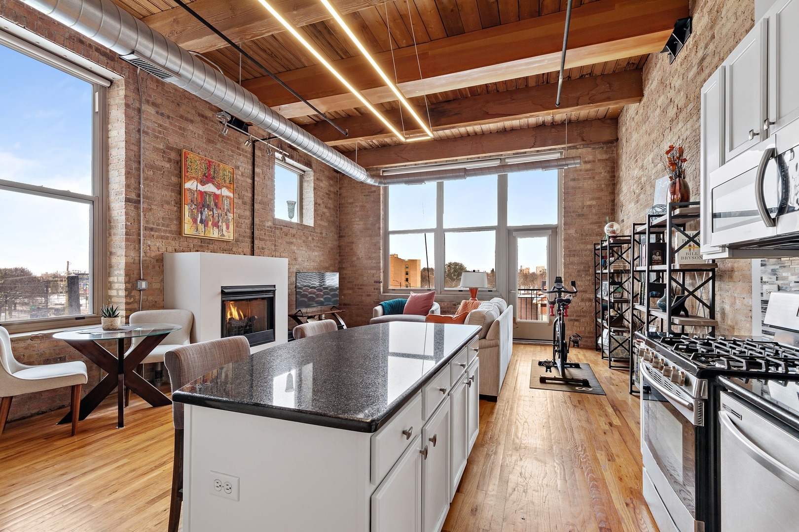 1500 West Monroe Street, Unit 401 Chicago, IL 60607 - Photo 12 of 24 a kitchen with a table chairs stove and cabinets
