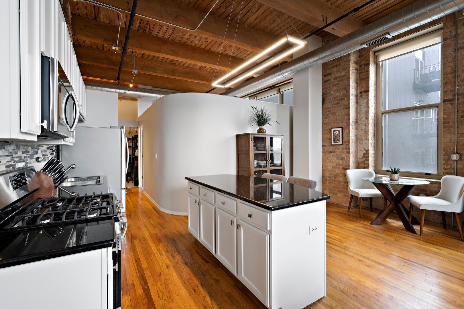 1500 West Monroe Street, Unit 401 Chicago, IL 60607 - Photo 14 of 24 a kitchen with granite countertop a stove and a refrigerator