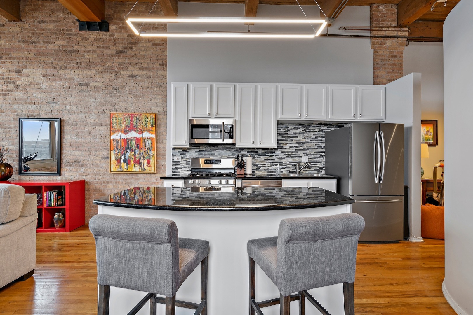 1500 West Monroe Street, Unit 401 Chicago, IL 60607 - Photo 15 of 24 a kitchen with stainless steel appliances granite countertop a table chairs microwave and sink