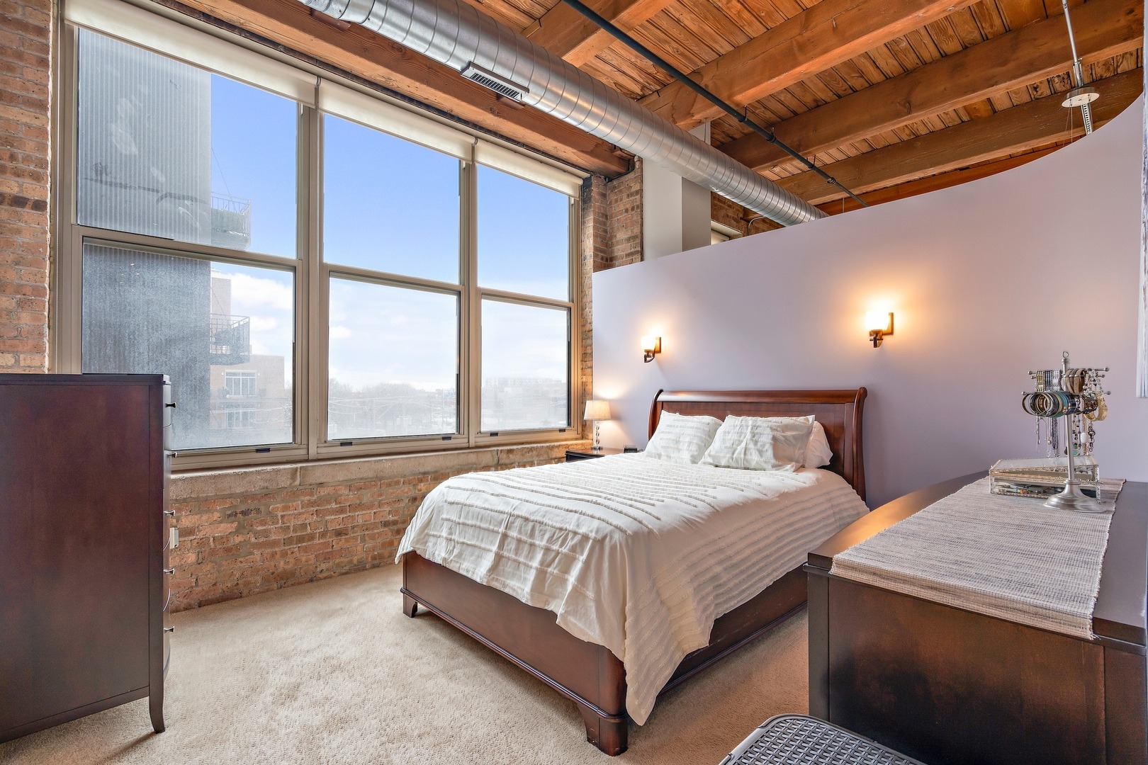 1500 West Monroe Street, Unit 401 Chicago, IL 60607 - Photo 16 of 24 a bed sitting in a bedroom next to a window