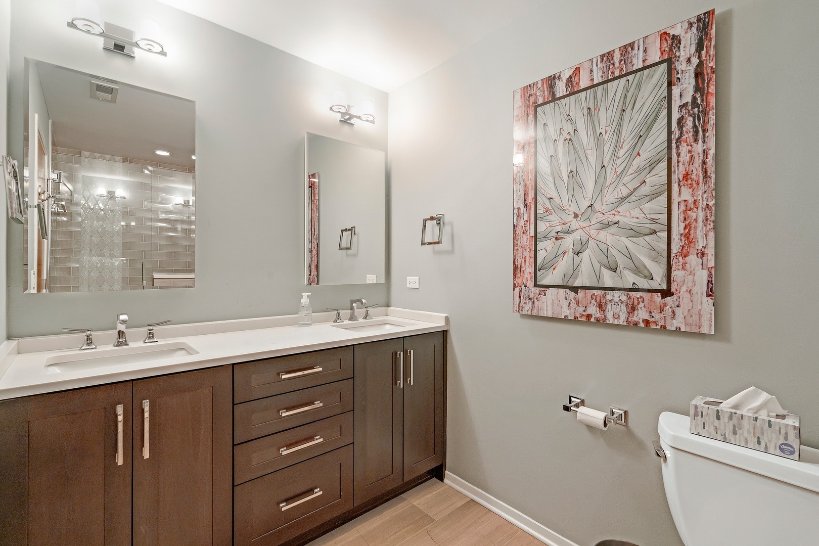 1500 West Monroe Street, Unit 401 Chicago, IL 60607 - Photo 18 of 24 a bathroom with a double vanity sink toilet and a mirror