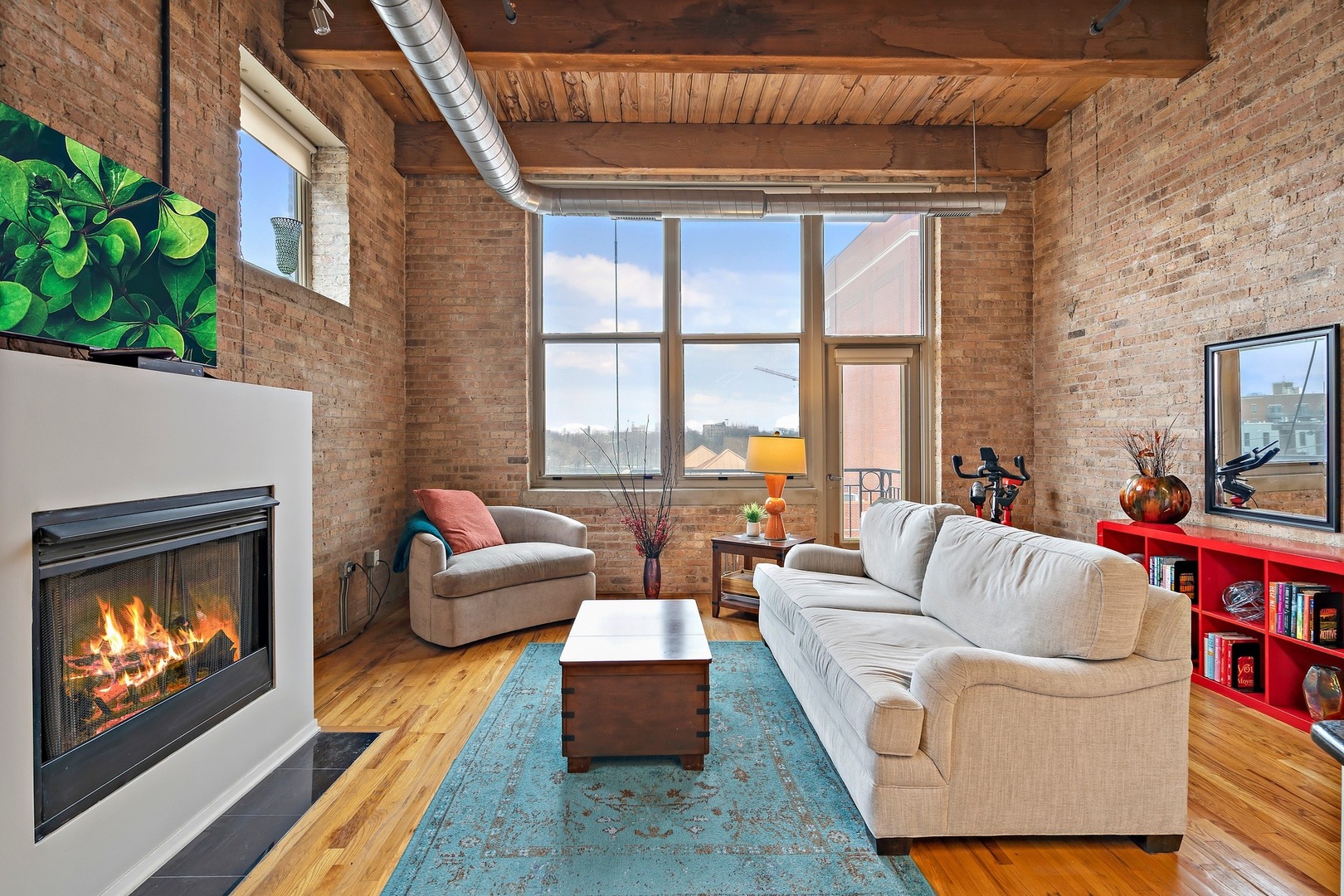 1500 West Monroe Street, Unit 401 Chicago, IL 60607 - Photo 4 of 24 a living room with furniture a fireplace and a floor to ceiling window