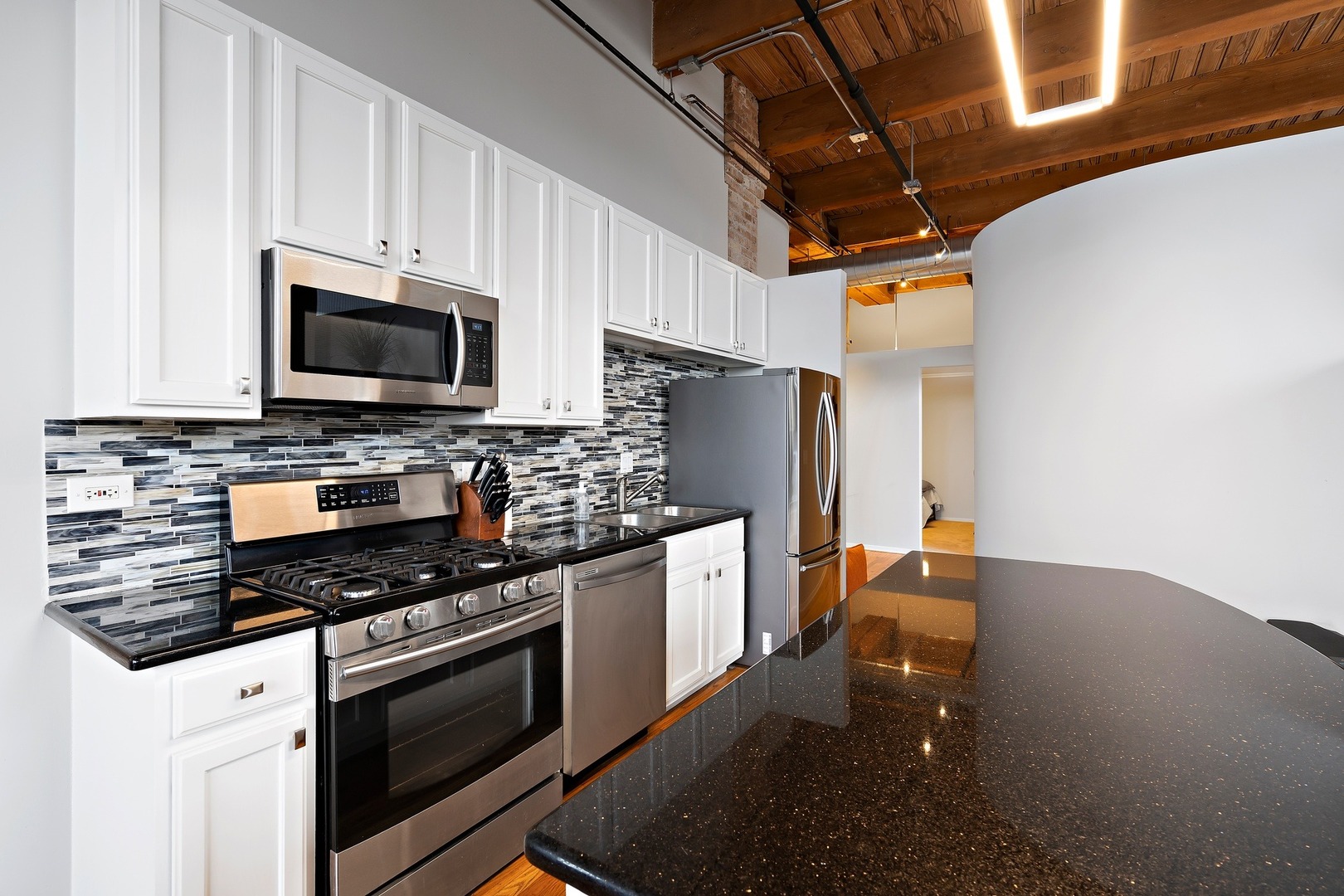 1500 West Monroe Street, Unit 401 Chicago, IL 60607 - Photo 8 of 24 a kitchen with stainless steel appliances a stove microwave and refrigerator