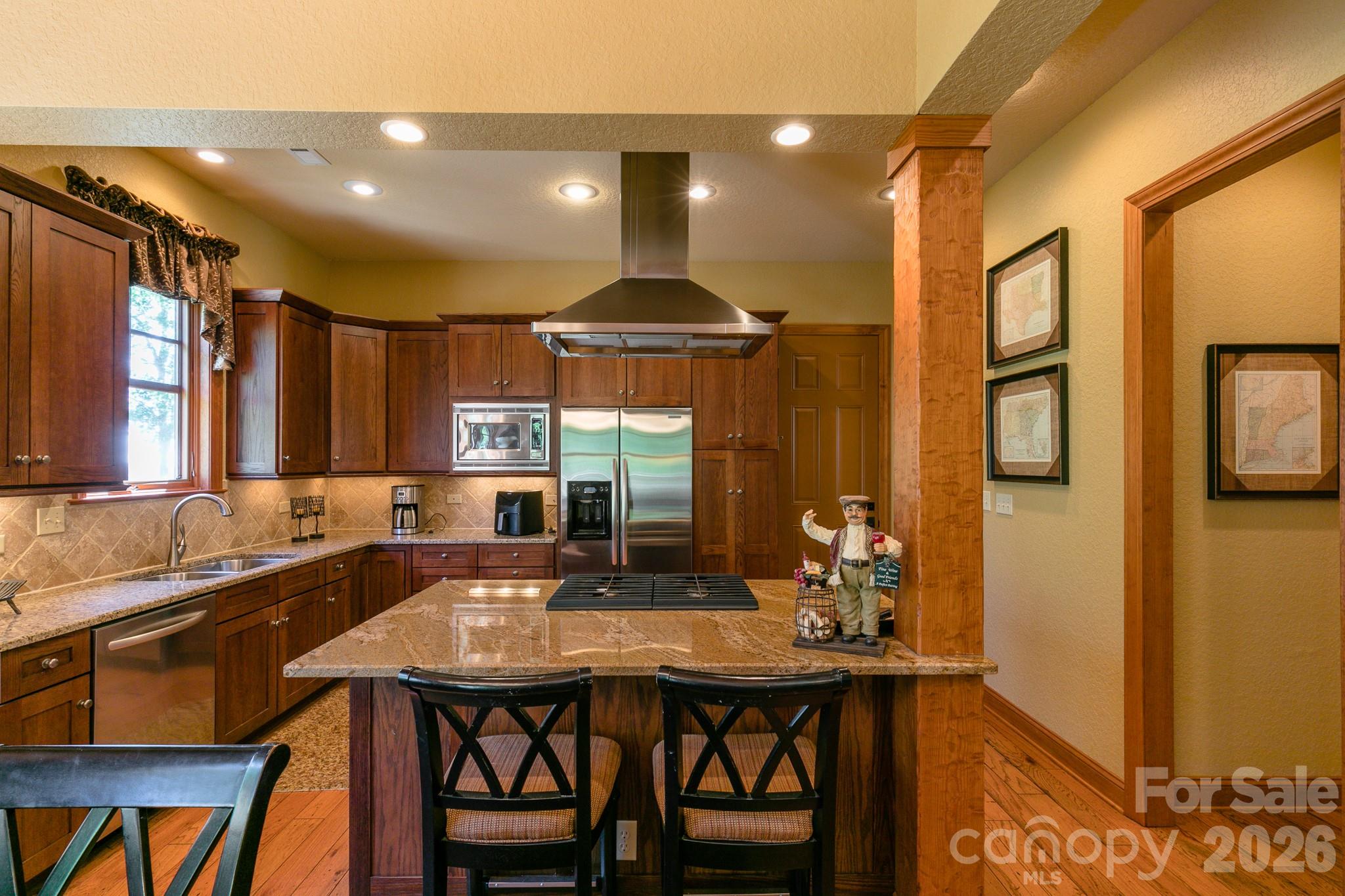 307 Spring Rock Road Burnsville, NC 28714 - Photo 4 of 34 a kitchen with a table chairs sink and cabinets