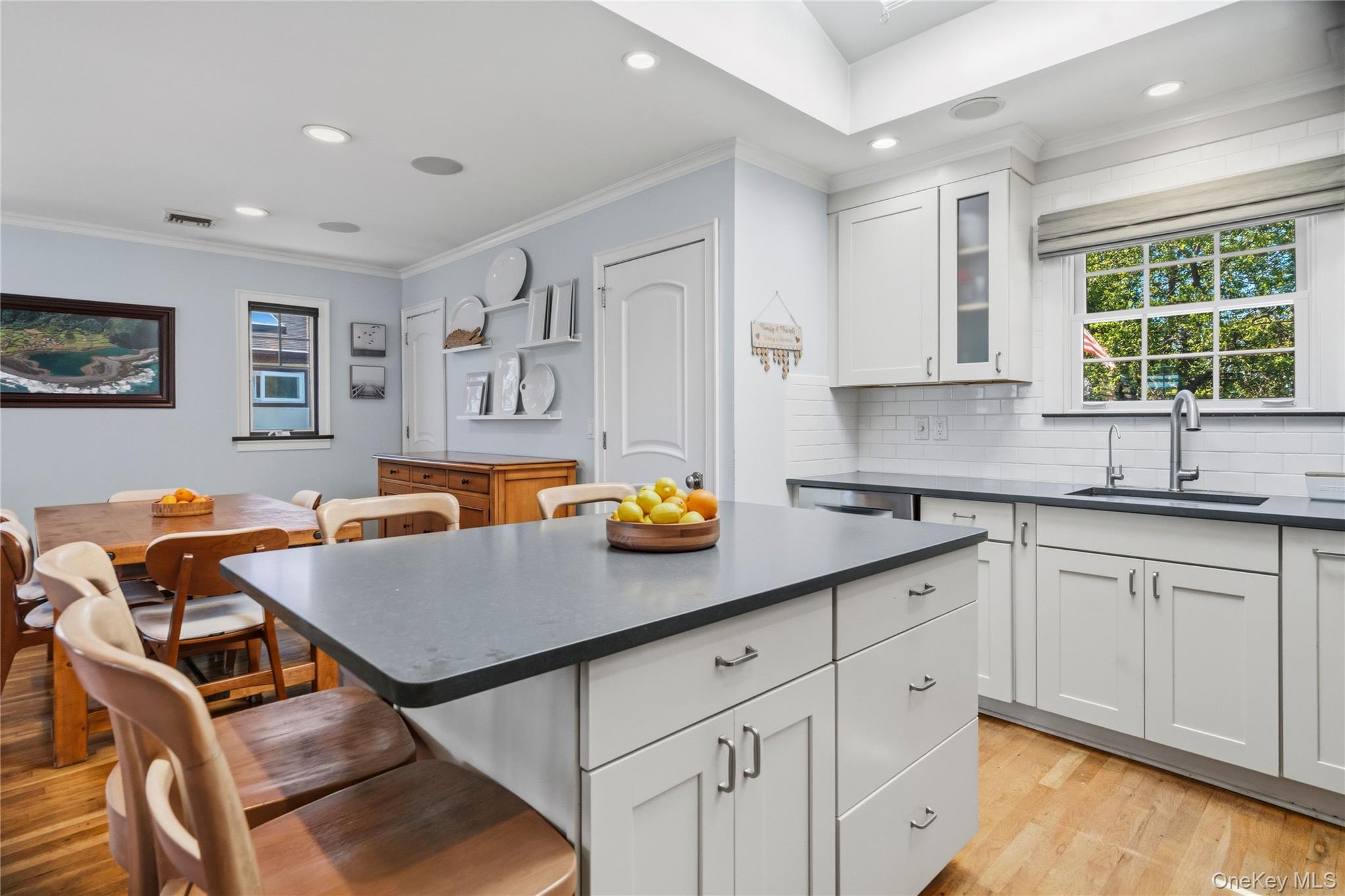 190 Sexton Road West Babylon, NY 11704 - Photo 14 of 28 a kitchen with stainless steel appliances granite countertop a stove a sink a dining table and chairs