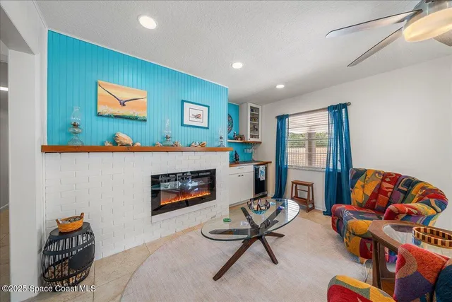 a living room with furniture a rug and a chandelier