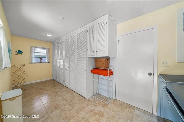 a view of a patio with a table chairs and a backyard