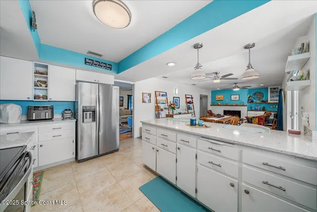 a kitchen with appliances a sink and cabinets