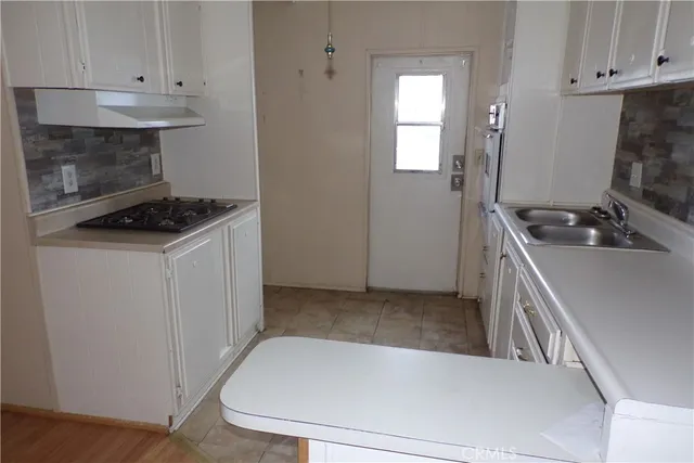 a kitchen with a stove and a sink