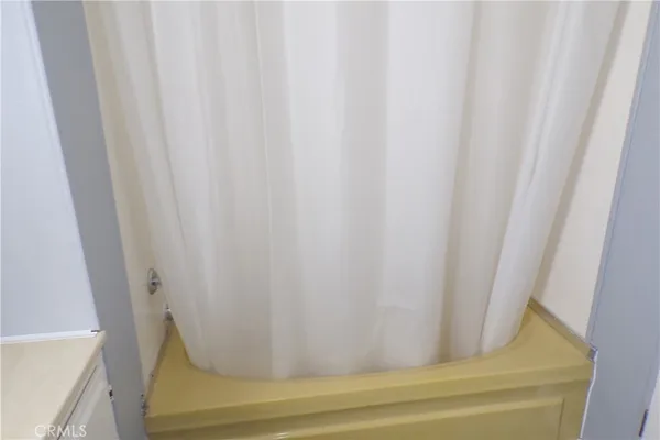 a bathroom with a granite countertop sink a toilet and mirror