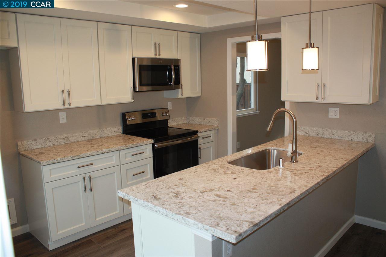 a kitchen with granite countertop a sink stove and refrigerator