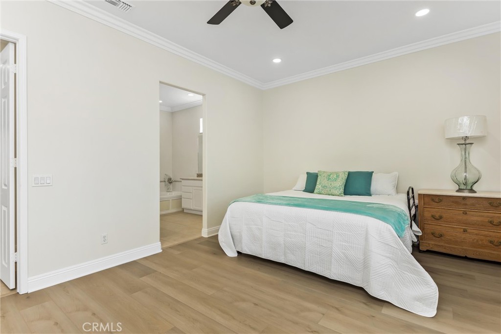 5233 Hampton Road Banning, CA 92220 - Photo 24 of 46 a bedroom with a bed and a chandelier