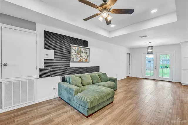 a living room with furniture and a wooden floor
