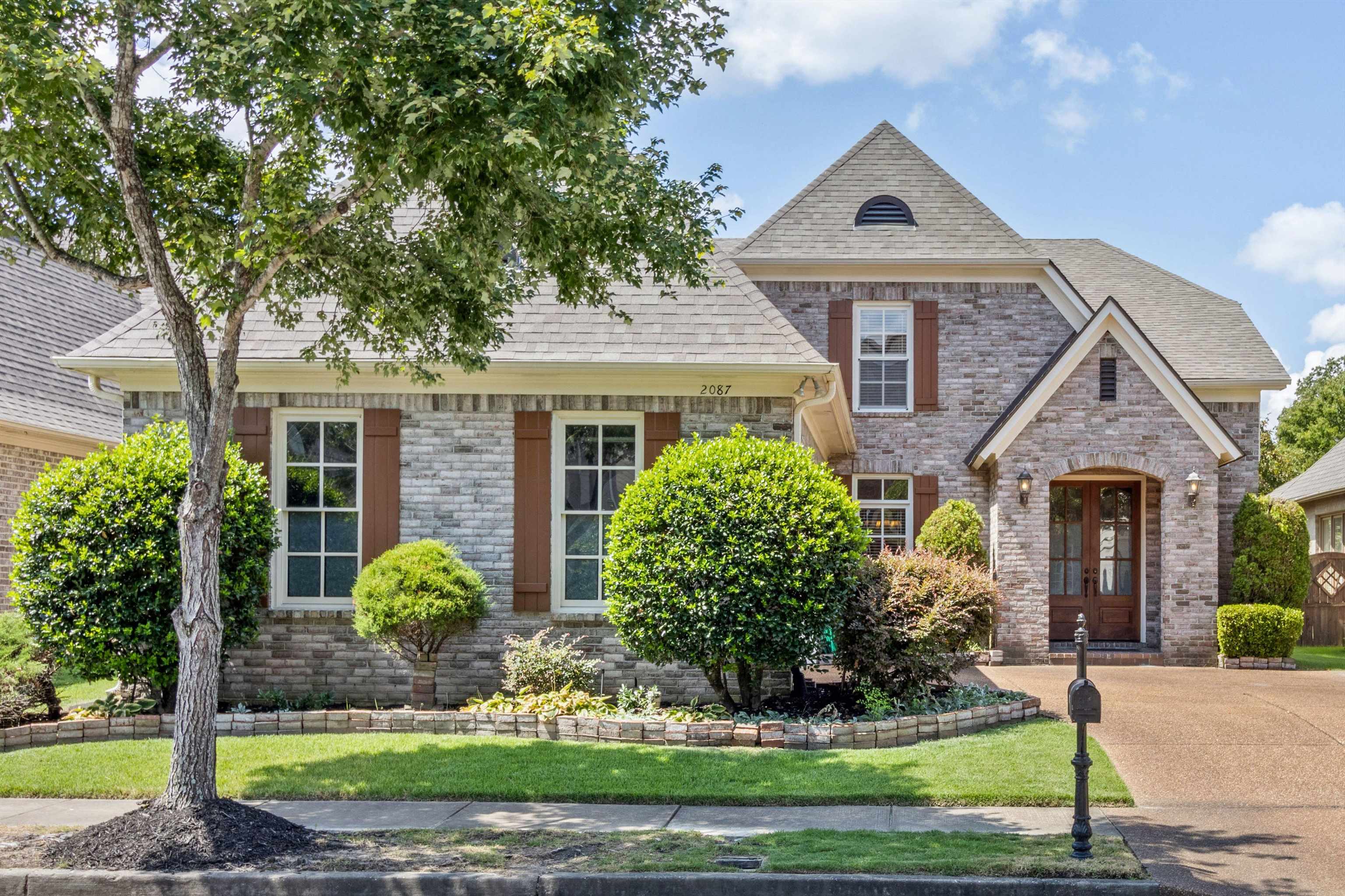 a front view of a house with garden