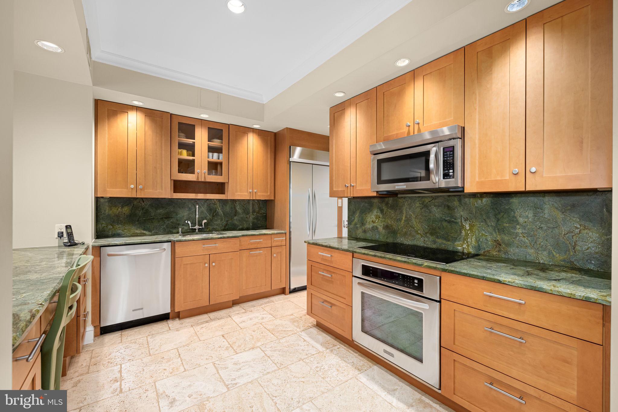 2700 Calvert Street Northwest, Unit 817 Washington, DC 20008 - Photo 23 of 64 a kitchen with stainless steel appliances granite countertop a stove microwave and sink