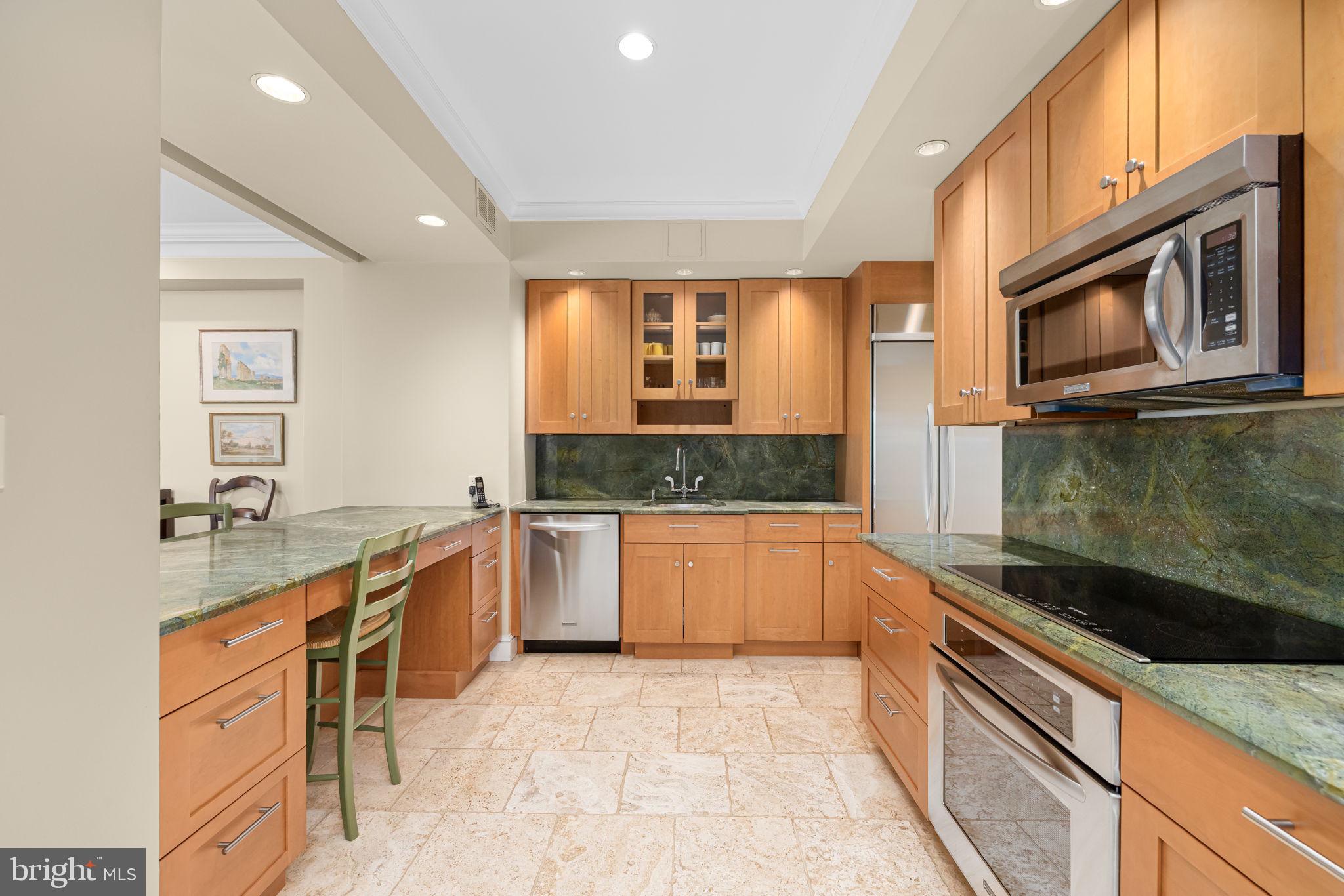2700 Calvert Street Northwest, Unit 817 Washington, DC 20008 - Photo 24 of 64 a large kitchen with stainless steel appliances granite countertop a stove a sink and a microwave
