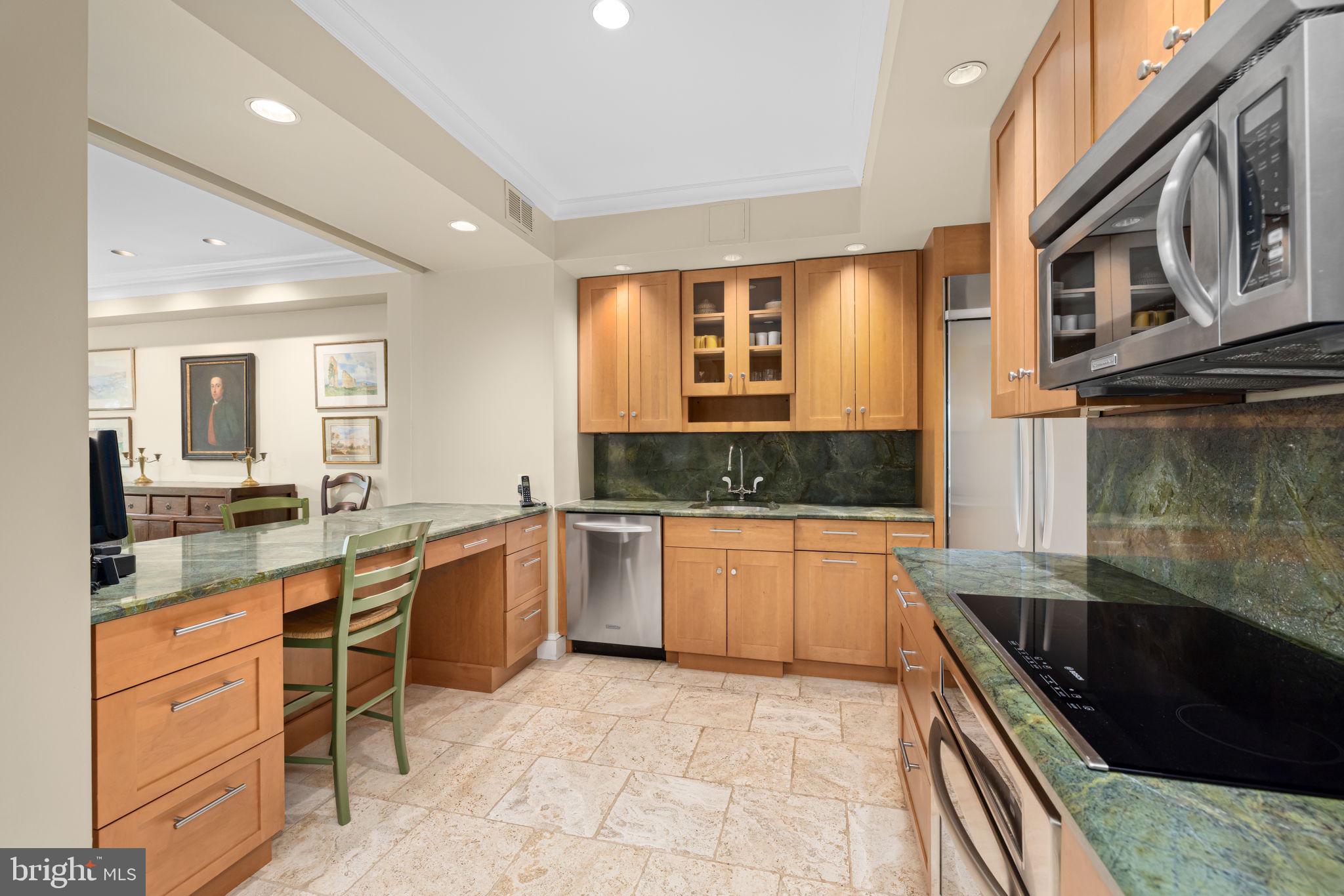 2700 Calvert Street Northwest, Unit 817 Washington, DC 20008 - Photo 25 of 64 a large kitchen with a large counter top space appliances and cabinets
