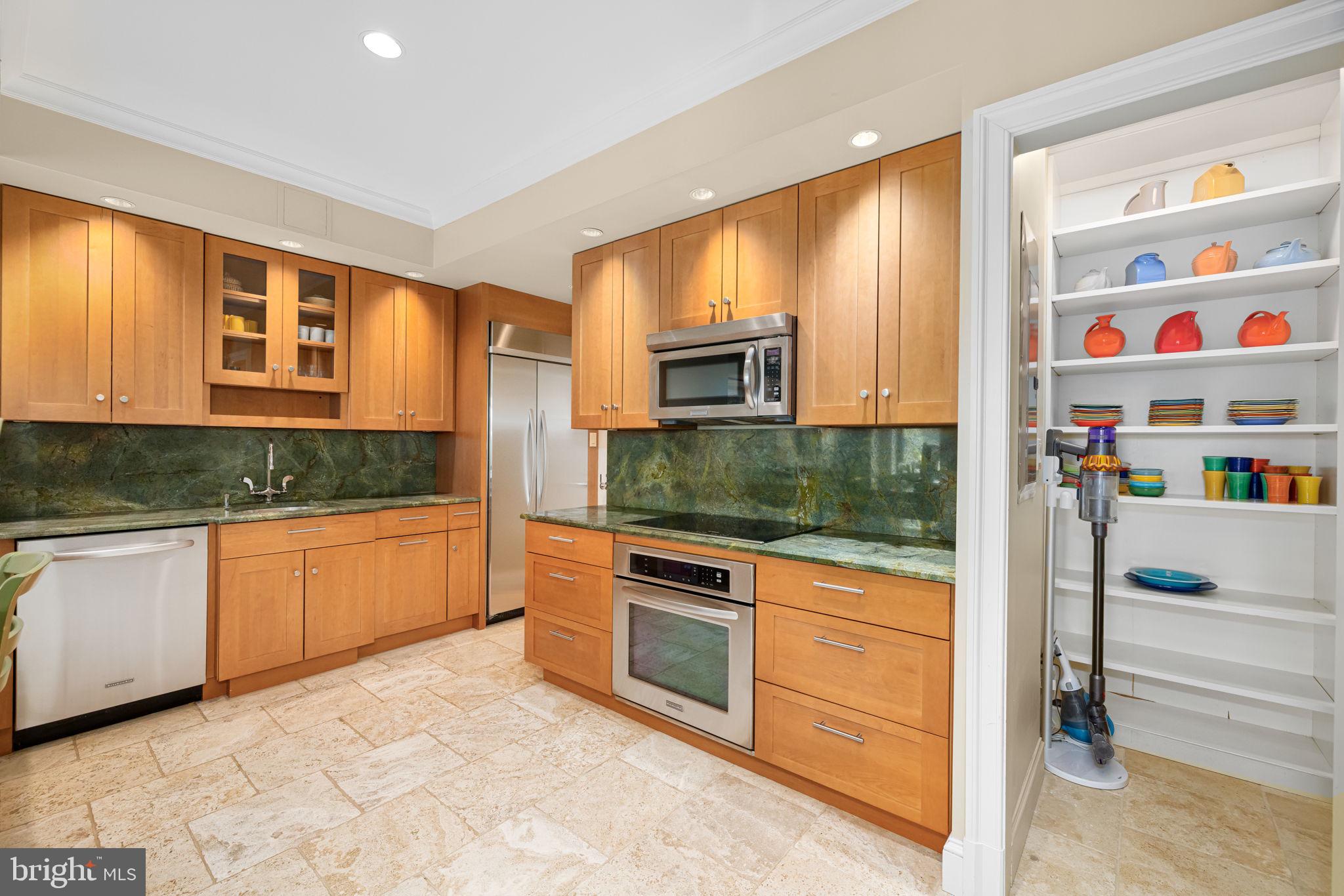2700 Calvert Street Northwest, Unit 817 Washington, DC 20008 - Photo 27 of 64 a kitchen with stainless steel appliances granite countertop a refrigerator and cabinets