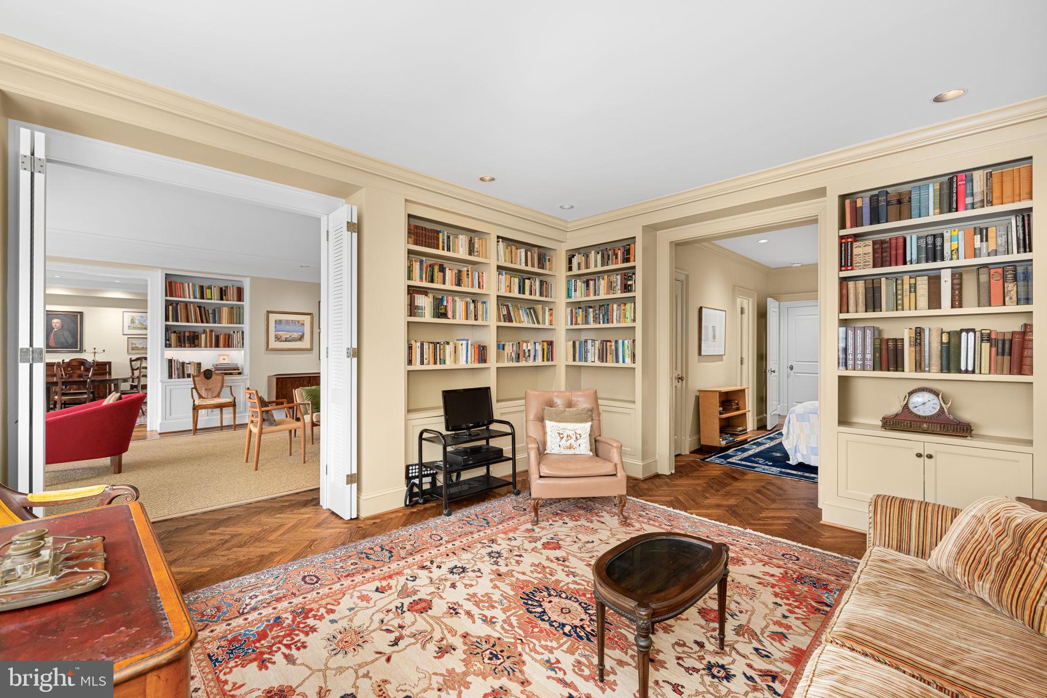 2700 Calvert Street Northwest, Unit 817 Washington, DC 20008 - Photo 30 of 64 a living room with furniture a rug and a bookshelf