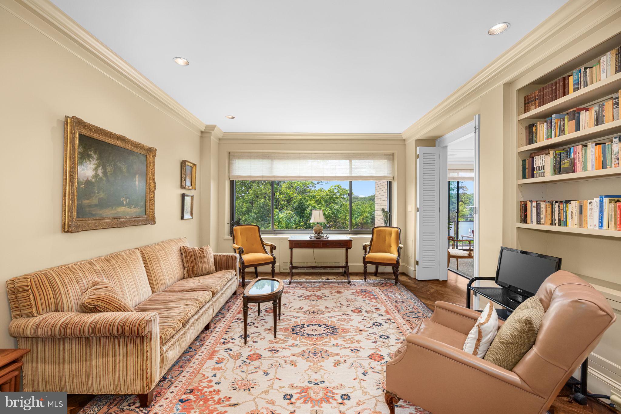 2700 Calvert Street Northwest, Unit 817 Washington, DC 20008 - Photo 31 of 64 a living room with furniture and a large window with bookshelf