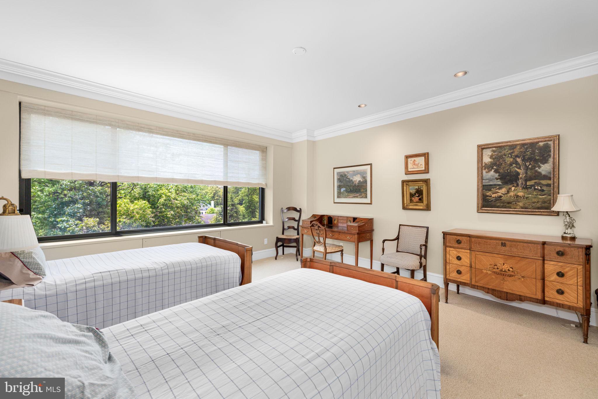 2700 Calvert Street Northwest, Unit 817 Washington, DC 20008 - Photo 41 of 64 a bedroom with a large bed and a dresser next to a window