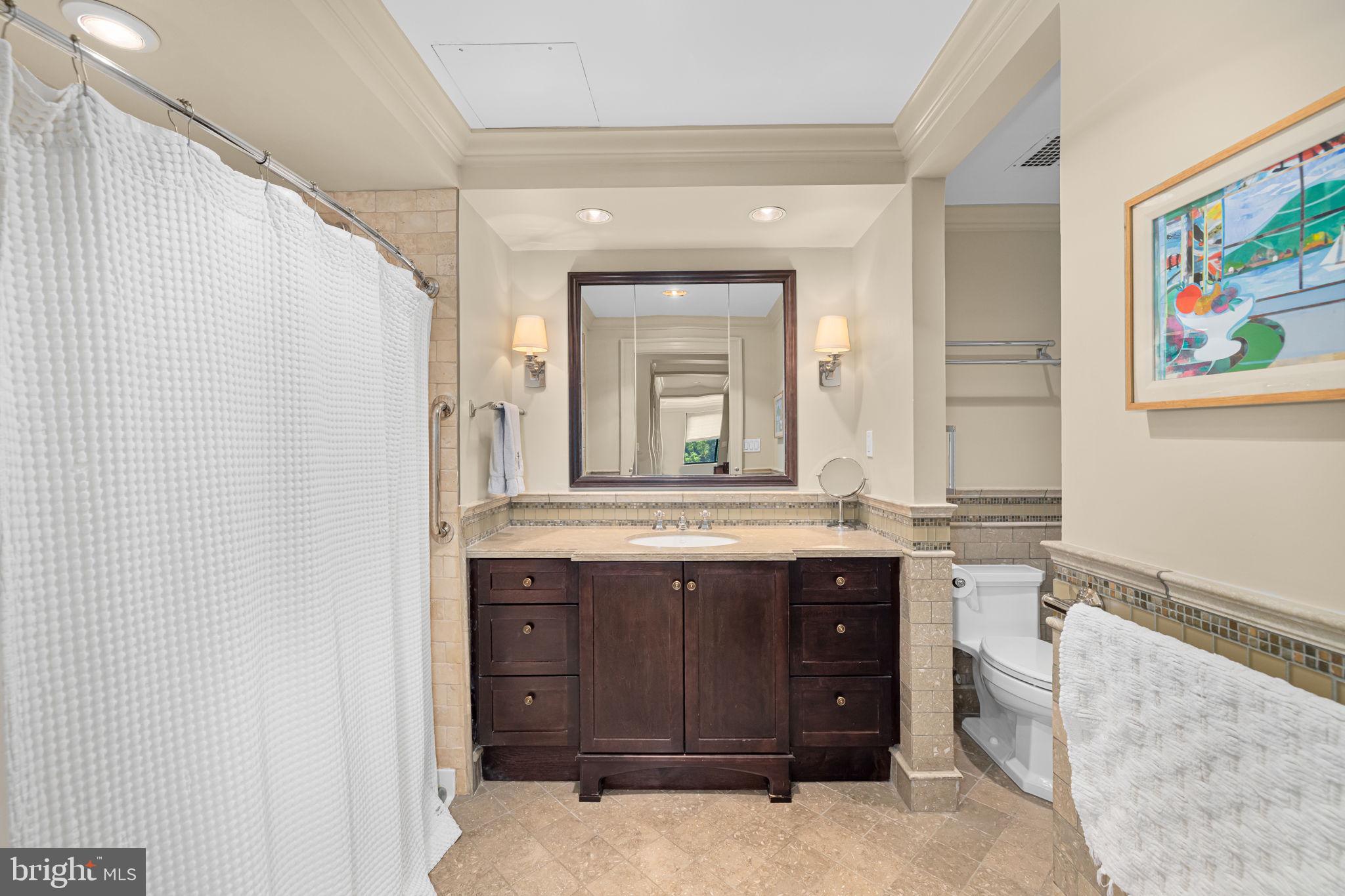 2700 Calvert Street Northwest, Unit 817 Washington, DC 20008 - Photo 44 of 64 a bathroom with a granite countertop sink and a mirror
