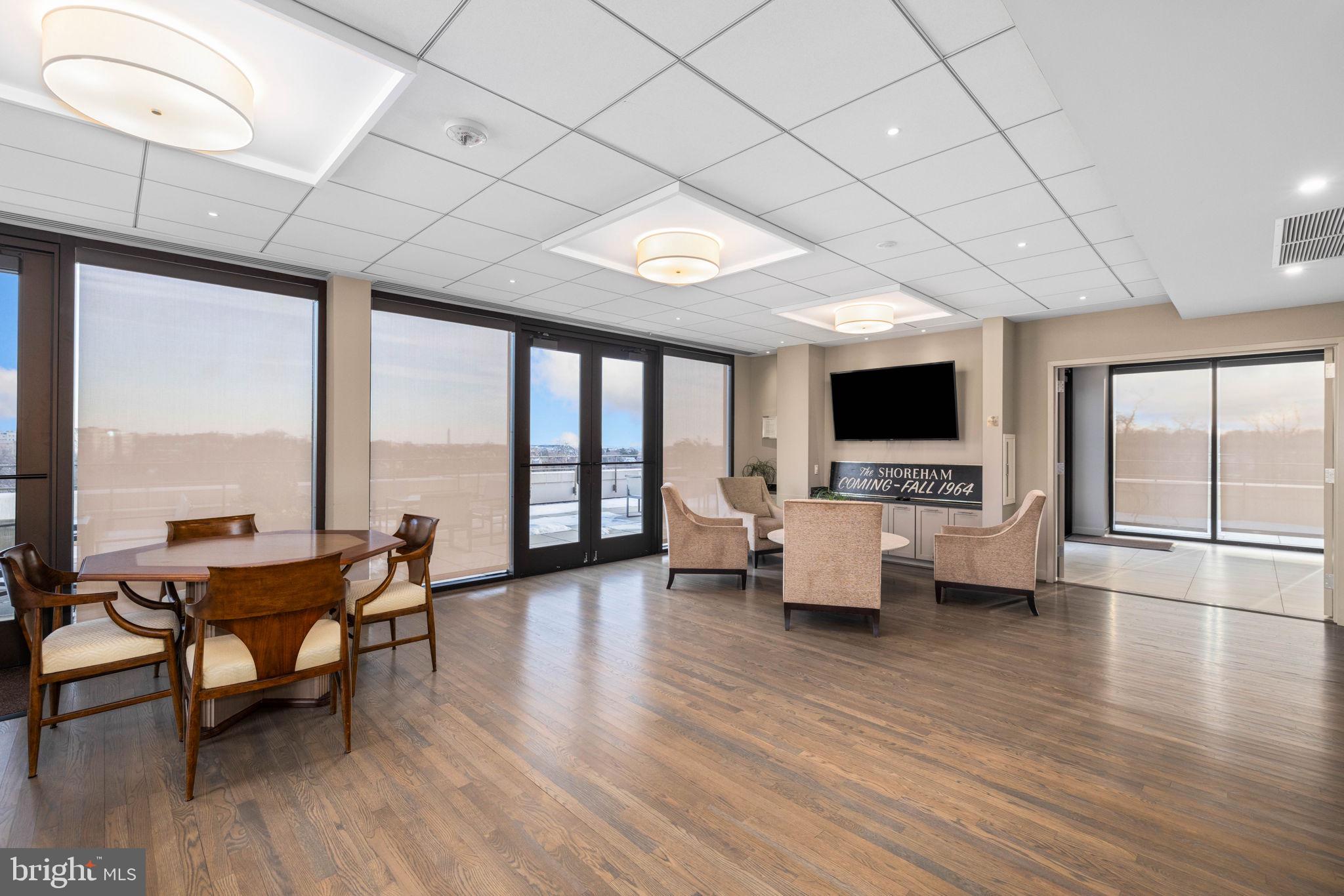 2700 Calvert Street Northwest, Unit 817 Washington, DC 20008 - Photo 60 of 64 a living room with furniture wooden floor and a floor to ceiling window