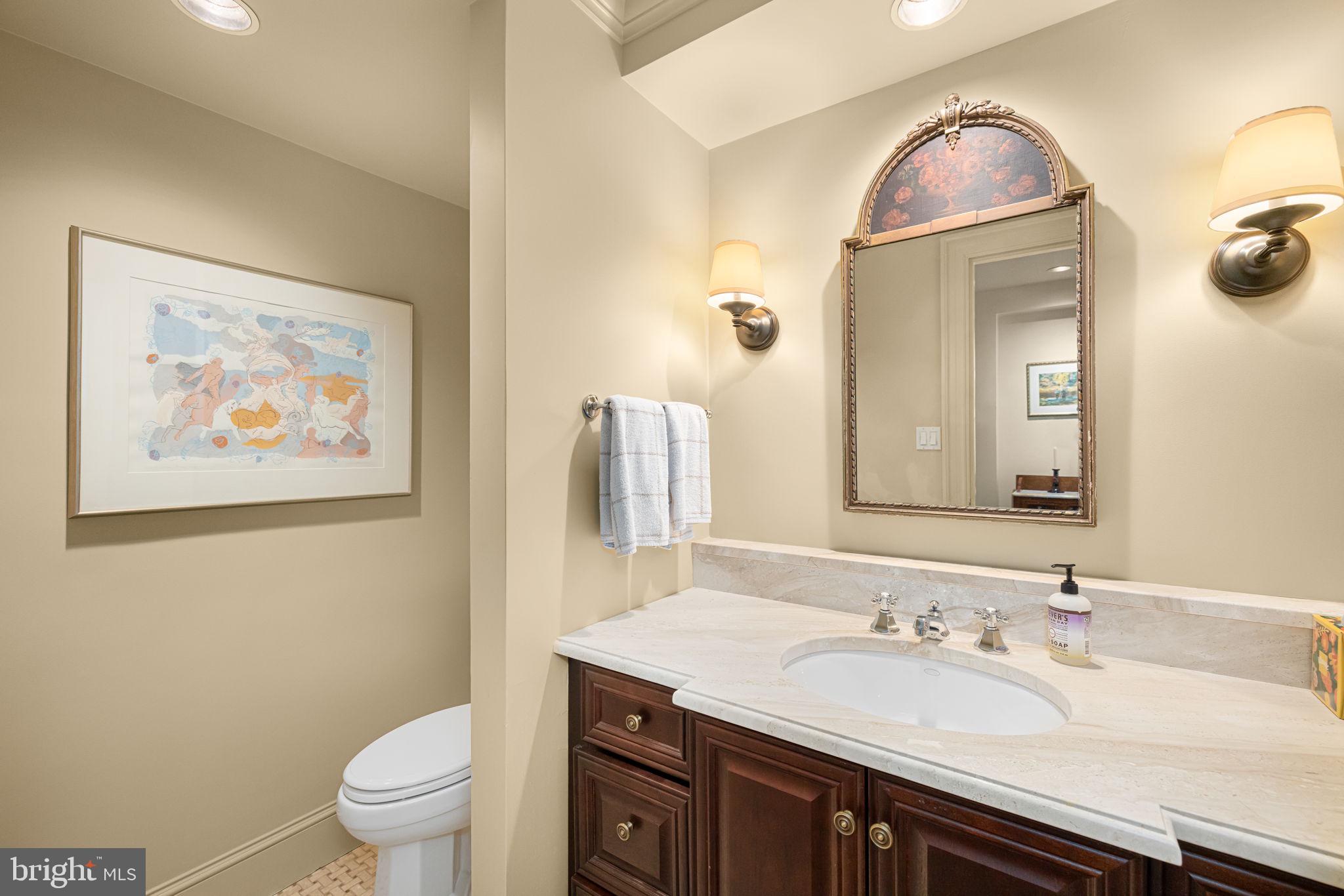 2700 Calvert Street Northwest, Unit 817 Washington, DC 20008 - Photo 7 of 64 a bathroom with a granite countertop sink mirror and toilet