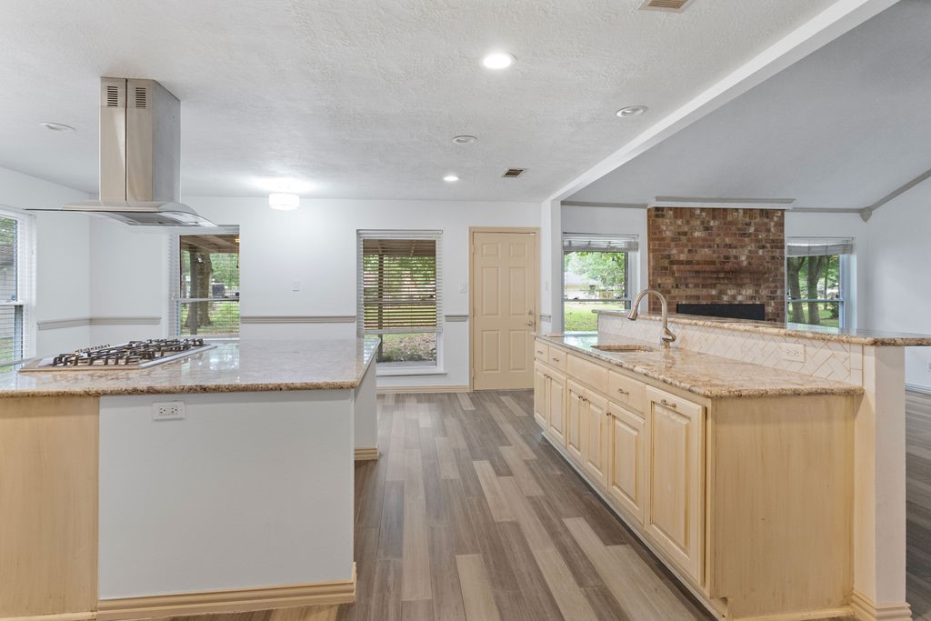 15050 Cardinal Trail Conroe, TX 77302 - Photo 12 of 44 a large kitchen with granite countertop a stove and a sink