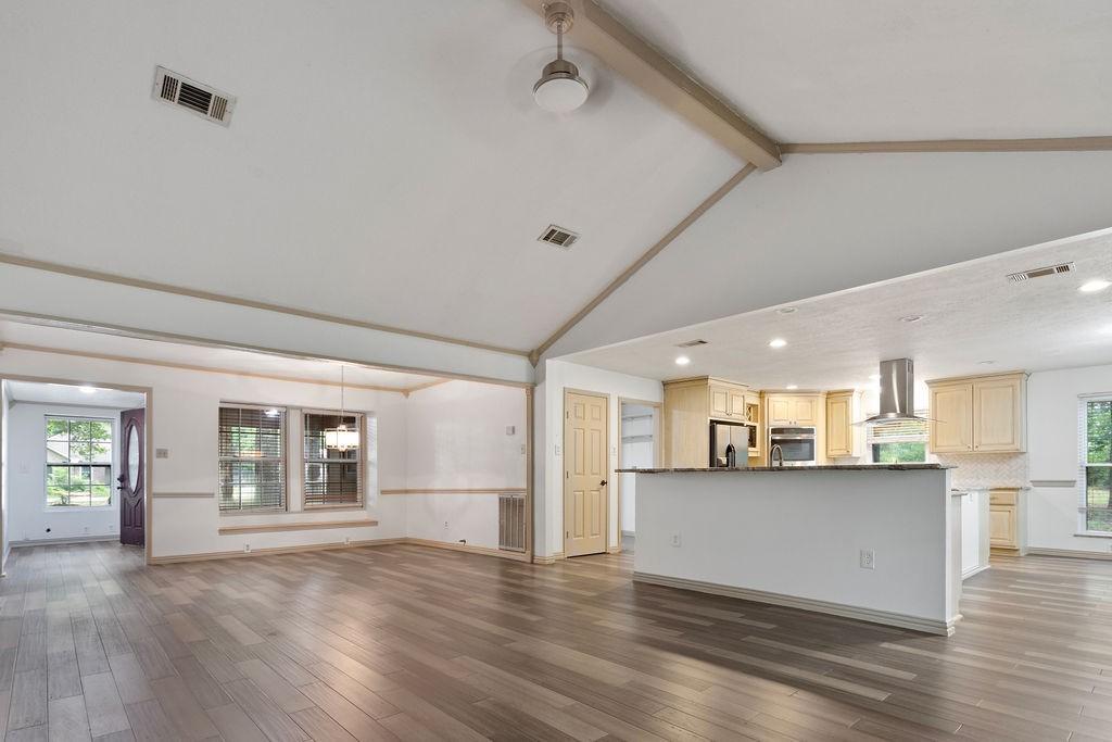 15050 Cardinal Trail Conroe, TX 77302 - Photo 2 of 44 a view of a kitchen with a sink wooden cabinets and a window