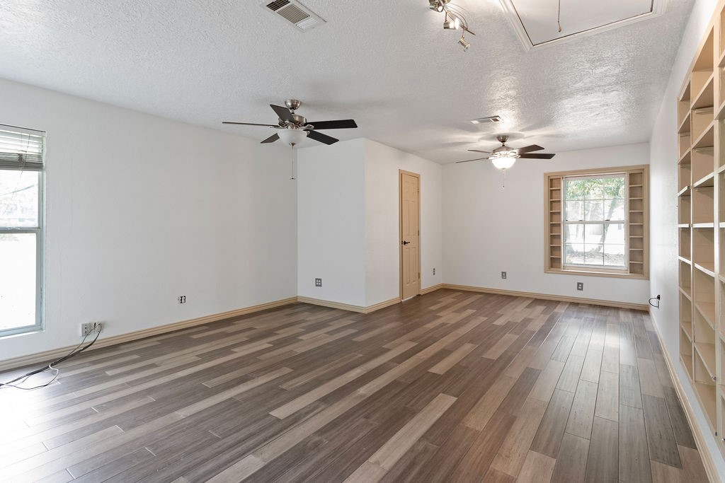 15050 Cardinal Trail Conroe, TX 77302 - Photo 22 of 44 wooden floor in an empty room with a window