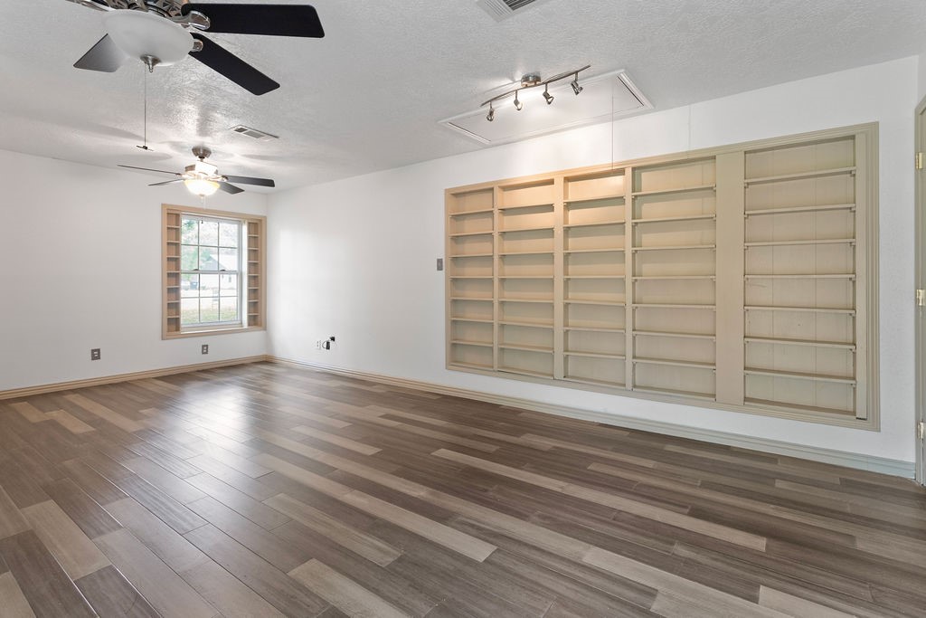 15050 Cardinal Trail Conroe, TX 77302 - Photo 23 of 44 wooden floor in an empty room with a window