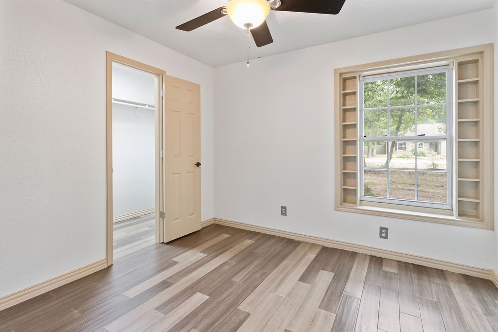 15050 Cardinal Trail Conroe, TX 77302 - Photo 24 of 44 a view of an empty room with wooden floor and a window