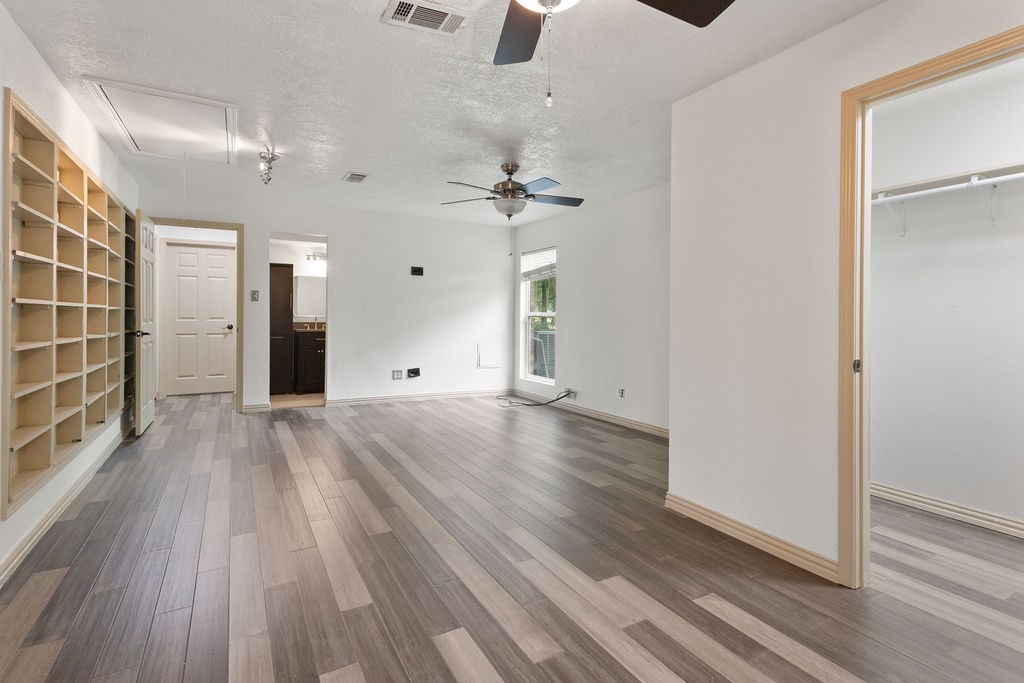 15050 Cardinal Trail Conroe, TX 77302 - Photo 26 of 44 wooden floor in an empty room with a window