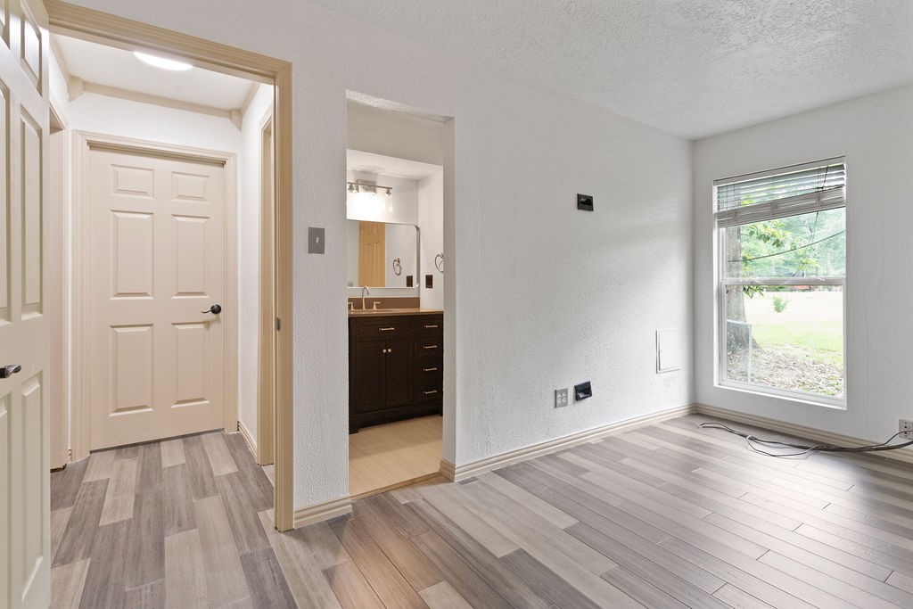 15050 Cardinal Trail Conroe, TX 77302 - Photo 27 of 44 a view of an empty room with wooden floor and a window
