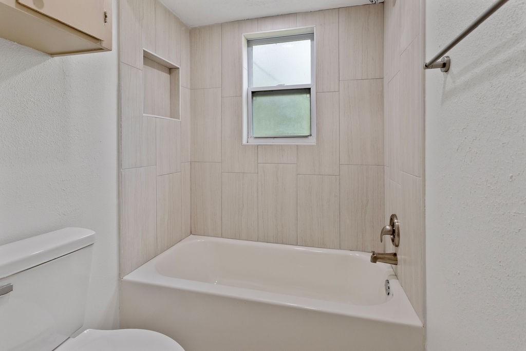 15050 Cardinal Trail Conroe, TX 77302 - Photo 29 of 44 a bathroom with a bathtub and a toilet