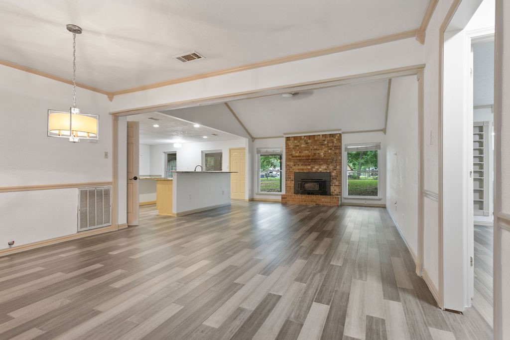 15050 Cardinal Trail Conroe, TX 77302 - Photo 3 of 44 a view of a hallway with wooden floor and a kitchen