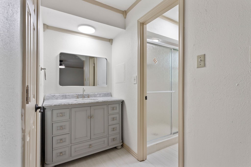 15050 Cardinal Trail Conroe, TX 77302 - Photo 31 of 44 a bathroom with a granite countertop sink vanity and mirror