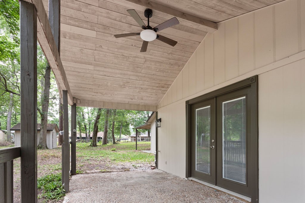 15050 Cardinal Trail Conroe, TX 77302 - Photo 41 of 44 a porch with a table and chairs in front of a house