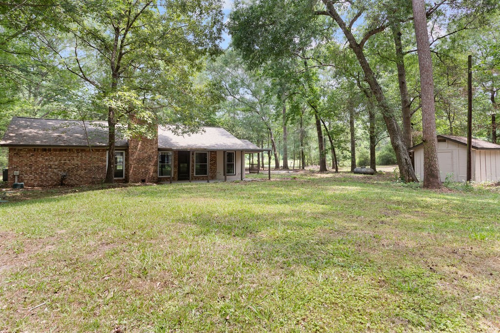 15050 Cardinal Trail Conroe, TX 77302 - Photo 42 of 44 a front view of a house with a yard