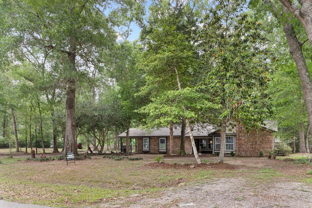 15050 Cardinal Trail Conroe, TX 77302 - Photo 44 of 44 front view of a house with a tiny house