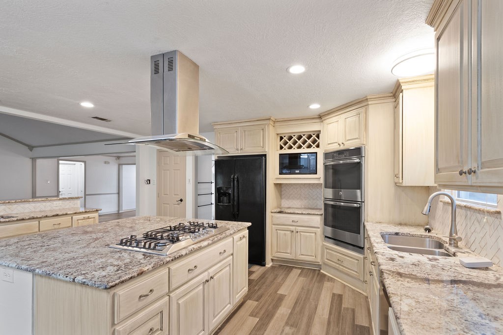15050 Cardinal Trail Conroe, TX 77302 - Photo 8 of 44 a kitchen with stainless steel appliances granite countertop a sink stove and refrigerator