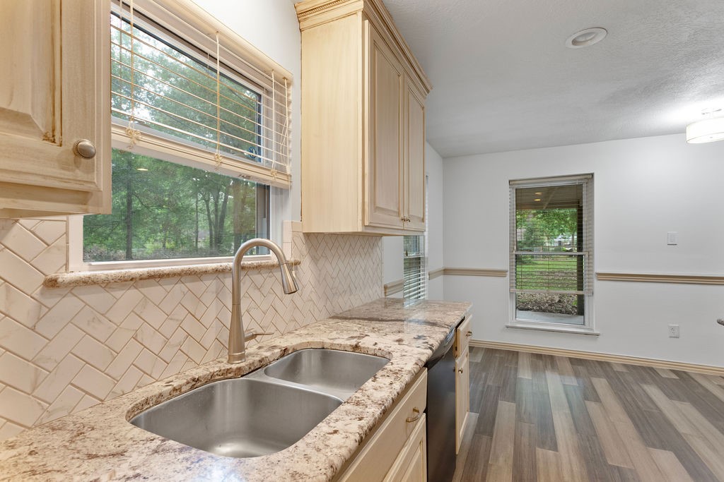 15050 Cardinal Trail Conroe, TX 77302 - Photo 10 of 44 a kitchen with a sink a counter top space and a window