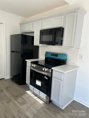 a kitchen with a stove and a microwave