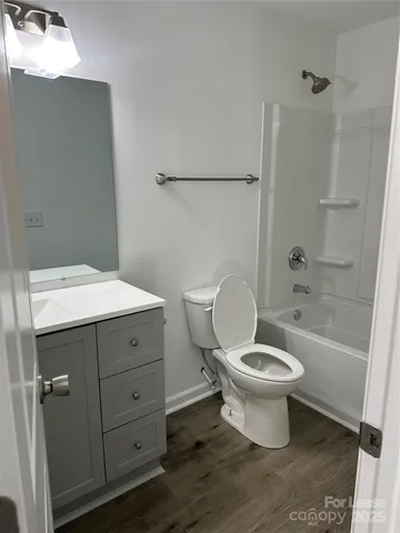 a bathroom with a sink toilet a mirror and shower