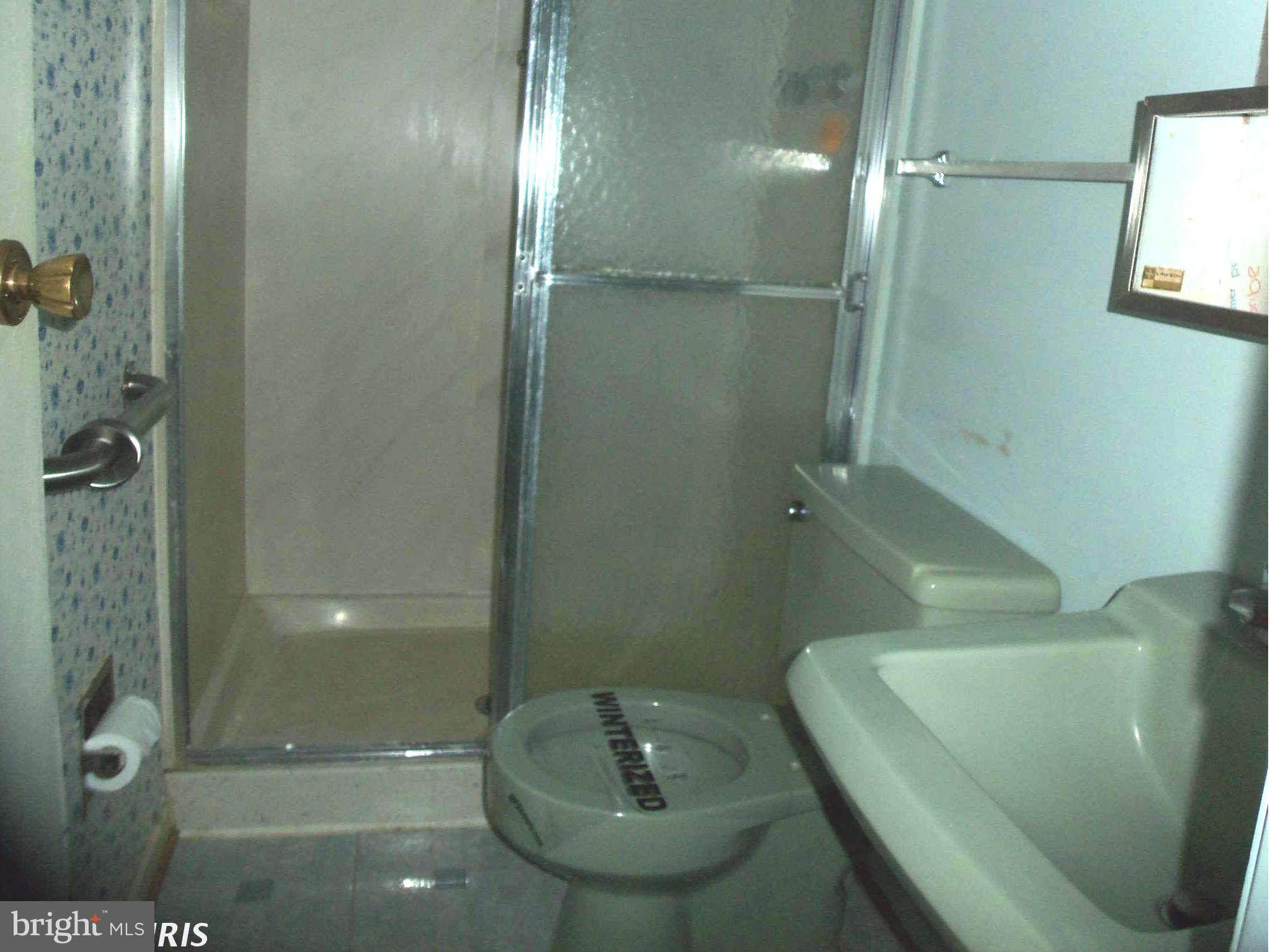 9619 Winands Road Randallstown, MD 21133 - Photo 14 of 20 a bathroom with a sink a toilet and shower