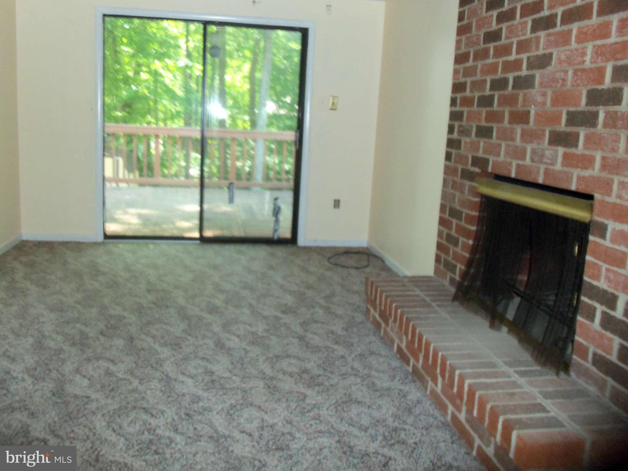 9619 Winands Road Randallstown, MD 21133 - Photo 4 of 20 a view of an empty room with a fireplace