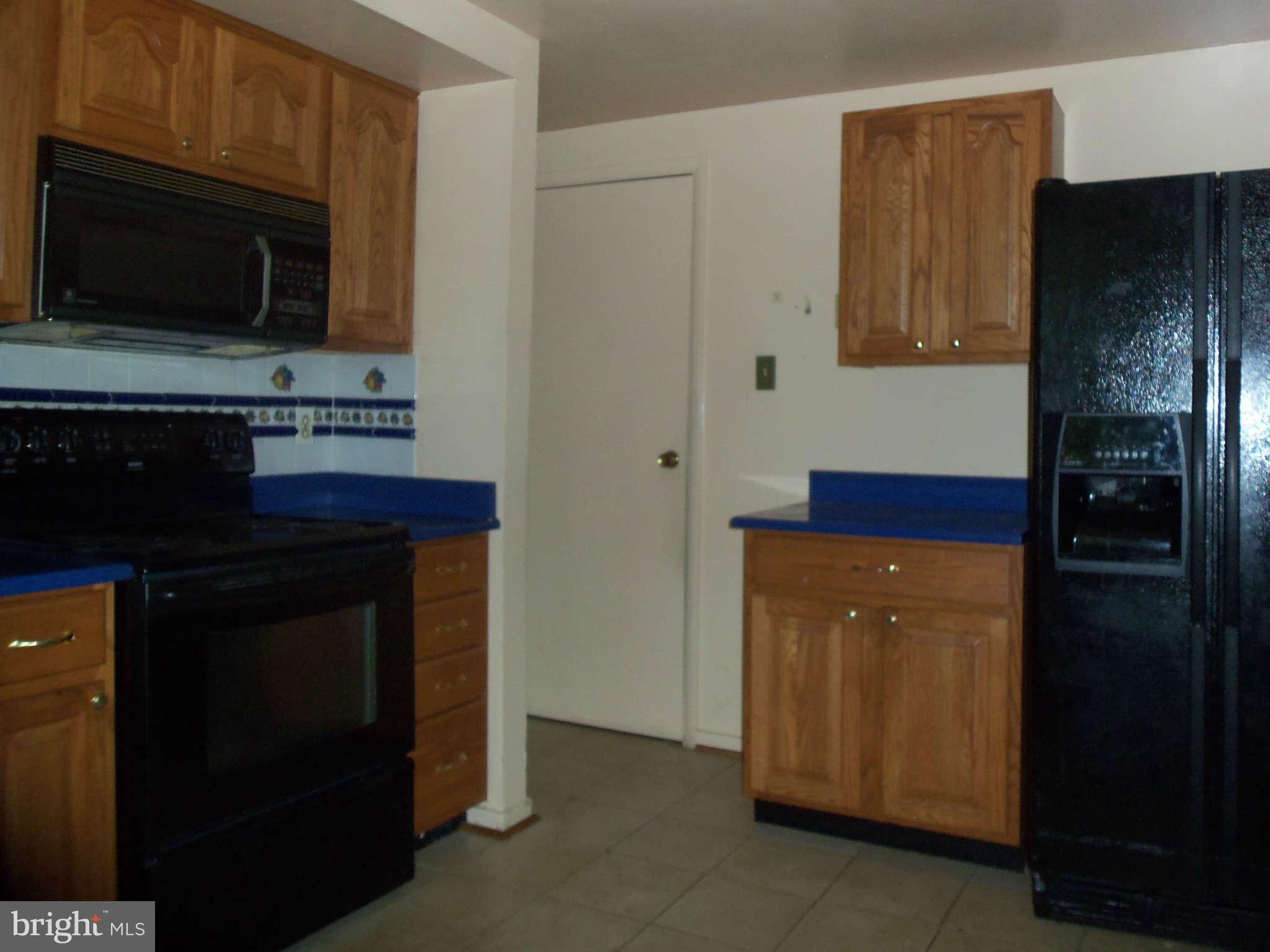 9619 Winands Road Randallstown, MD 21133 - Photo 7 of 20 a kitchen with stainless steel appliances a stove and a refrigerator