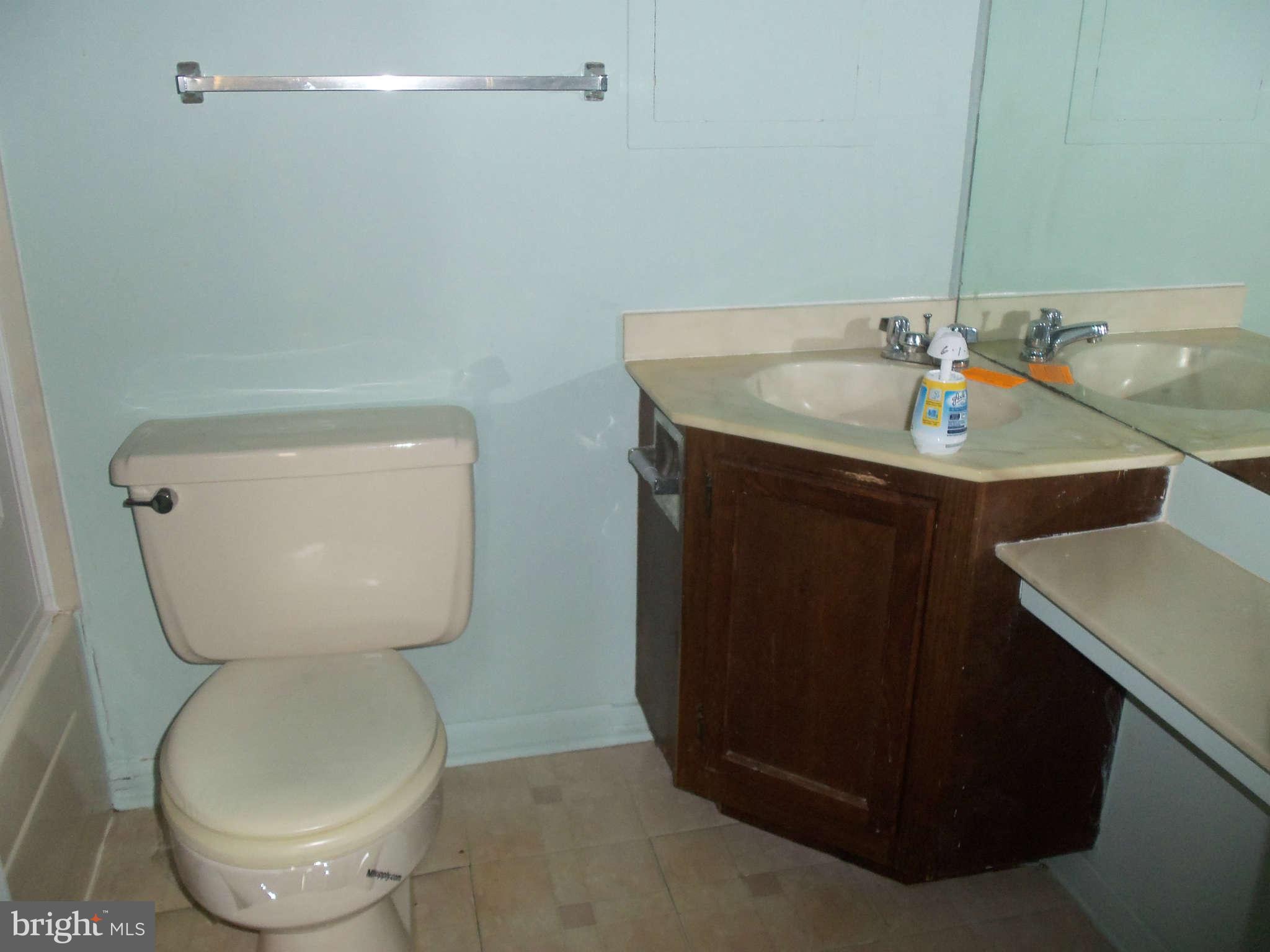 9619 Winands Road Randallstown, MD 21133 - Photo 9 of 20 a bathroom with a toilet sink and mirror