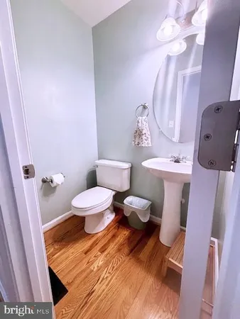 a bathroom with a sink mirror vanity and toilet